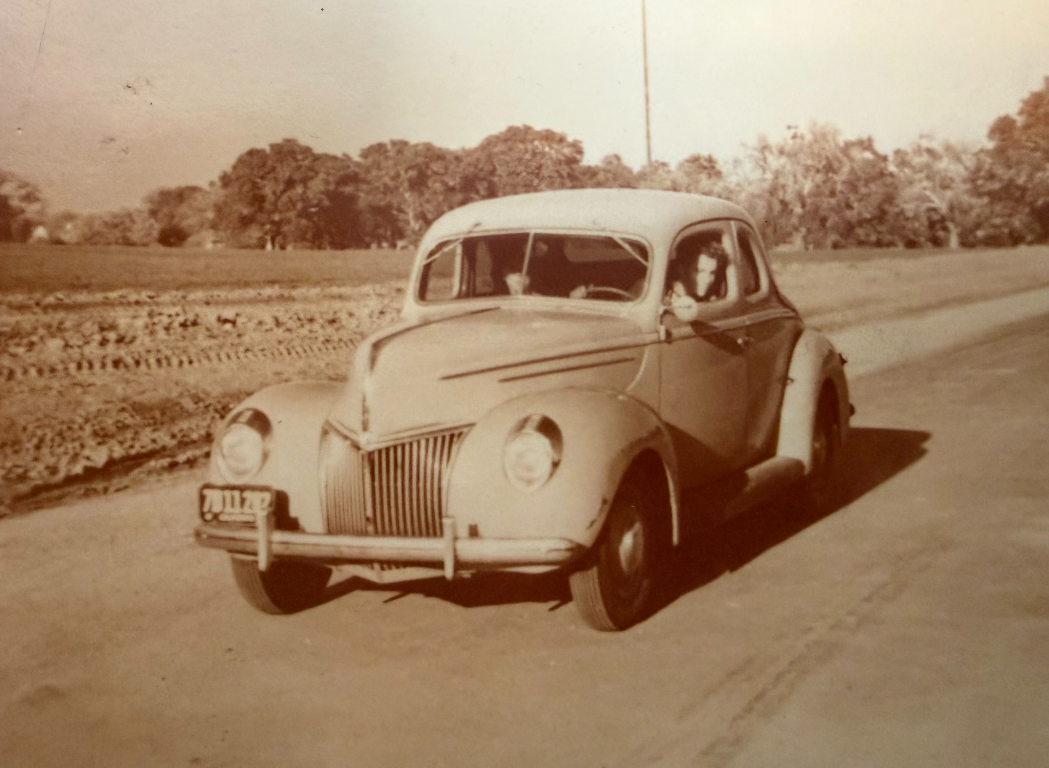Historical photograph of a vintage Ford on the road